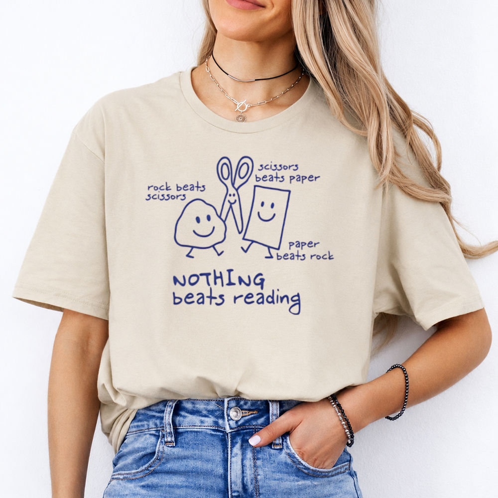 books over people shirt with 'Nothing Beats Reading' doodle